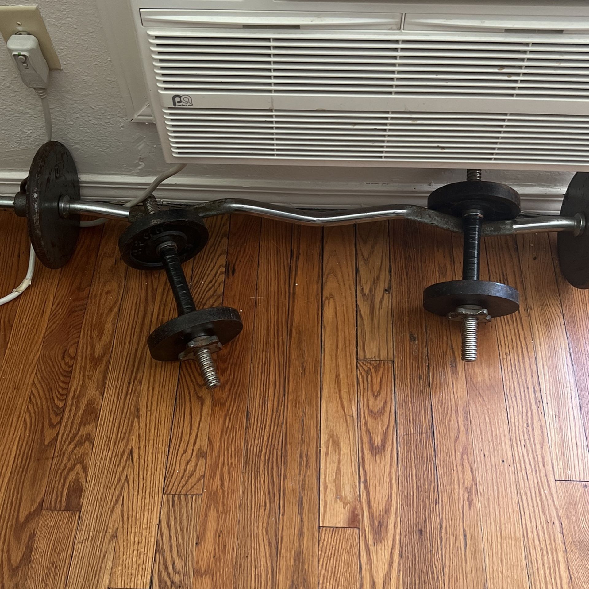 Curling bar to dumbbells hundred pounds in plates varying from 5 pounds to 10 pounds