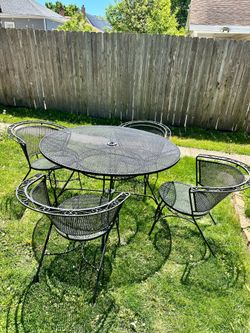 Wrought iron patio set, 48” table and 4 chairs