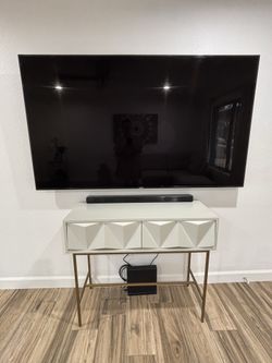 75” Samsung Smart TV and 50” Modern Contemporary Off-White Geometric Entry Table.
