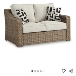 Signature Design by Ashley Beachcroft Wicker Outdoor Loveseat With Cushions