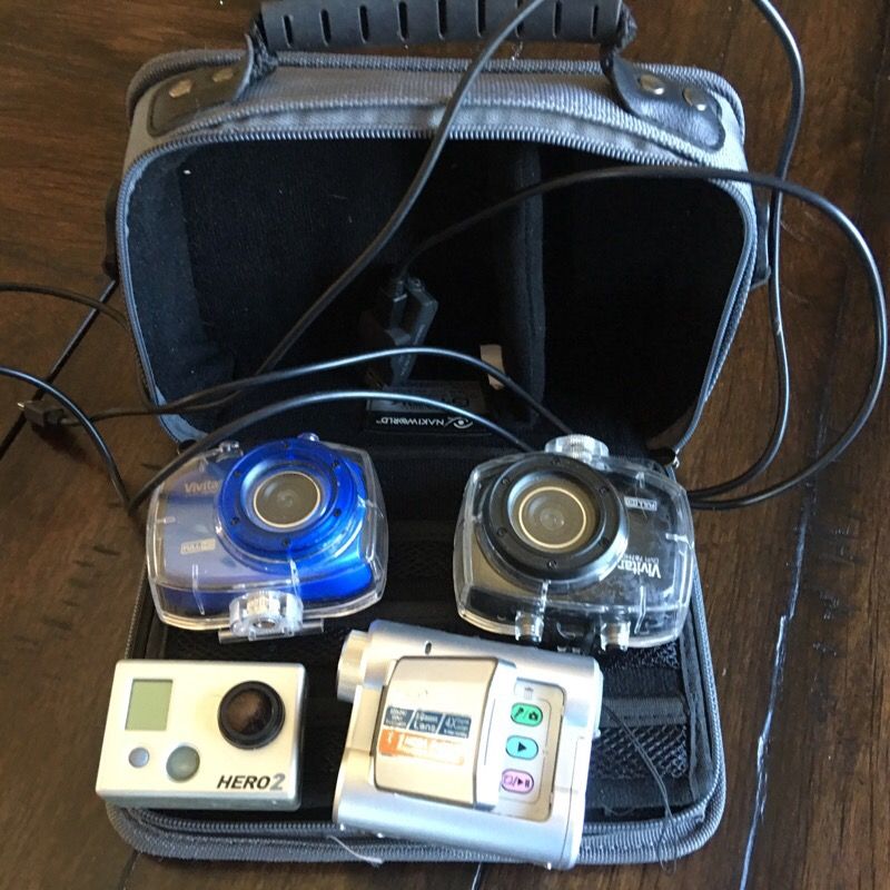 Two Vivitar DVR 787 HD cameras w/covers, 1 Hero2, and Digigr 8 3.1 Mega Pixels Video Camera with case