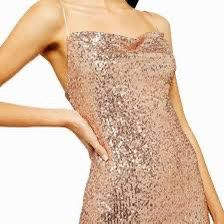 This stunning mini dress from Topshop is the perfect addition to your holiday wardrobe. Featuring a beautiful rose gold color and dazzling sequin acce