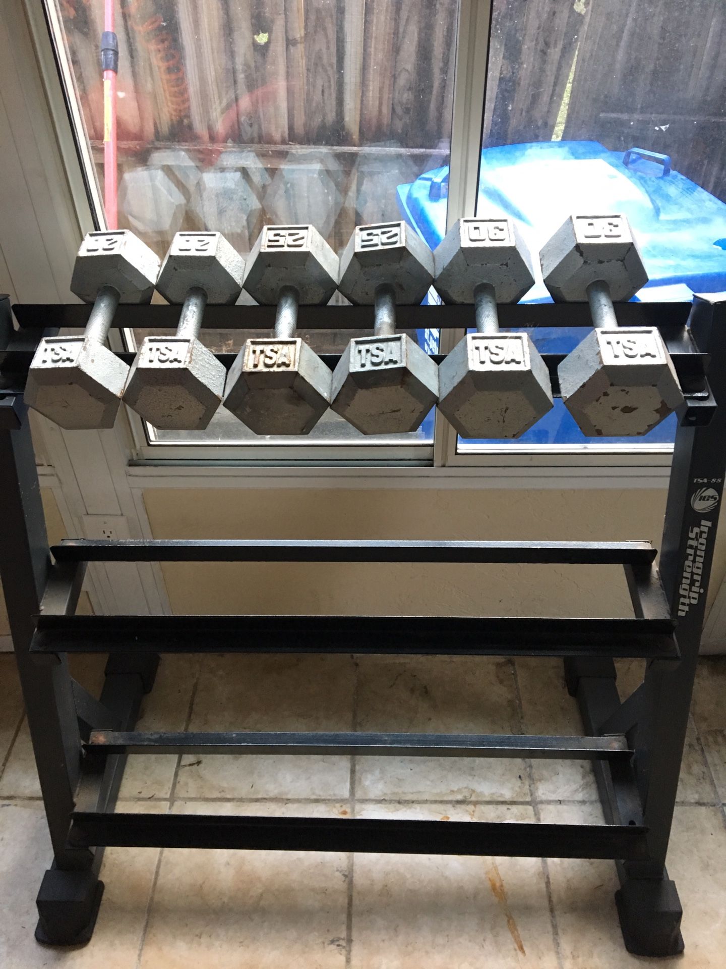 Dumbbell rack with three sets of dumbbells