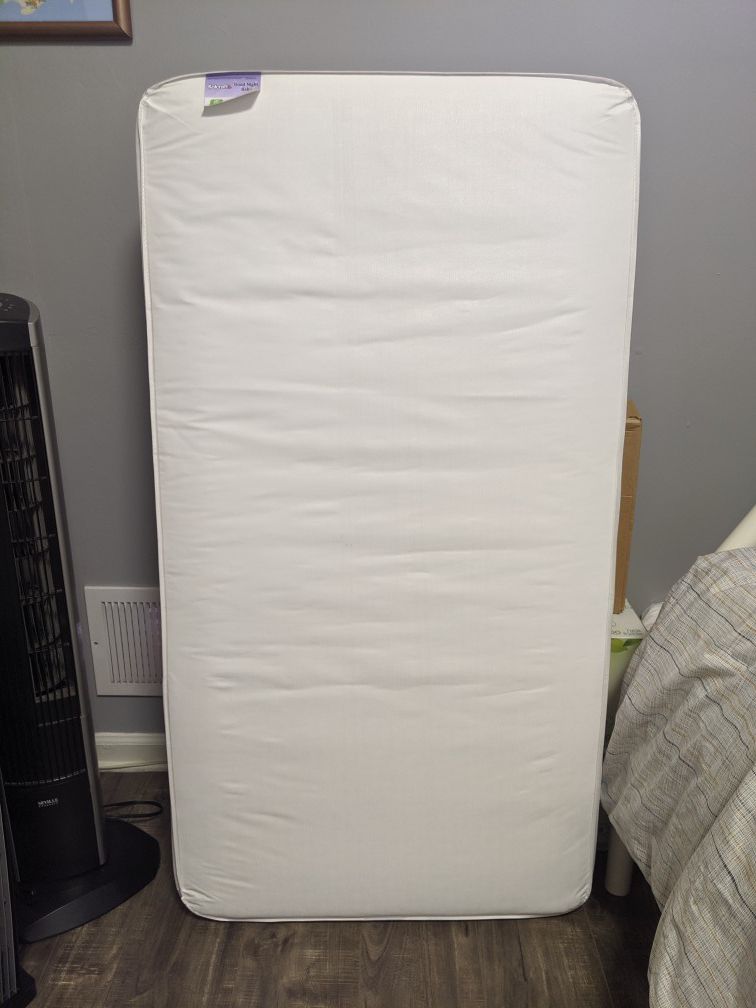 Standard crib mattress with fitted sheet