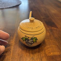 Vintage wooden honey pot with a lid and a small wooden dipper from Peru