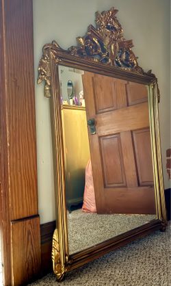 19th-century French gilded wood and gesso mirror with an ornate crest