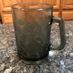 Vintage McDonald’s Gray Smoke Mug Glass.  Grimace playing Basketball.  .  Size 4 1/2 inches tall and 3, inches wide across the rim.  Capacity 4 ounces