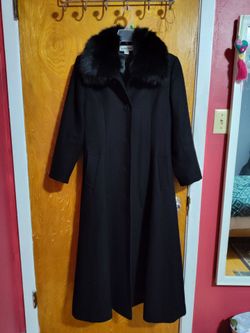 Black Jonathan Michael wool maxi coat with a faux fur collar.
