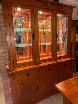 Mission lighted hutch with leaded glass and bar height dining table with 6 chairs. Solid wood.