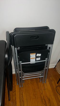 8 black fold in chairs.
