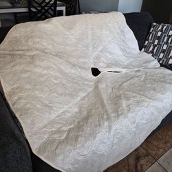 Two Christmas tree skirts: one is cream-colored (large size), and the other is gold-colored with small sparkles and gray (medium size)  $8.00  each