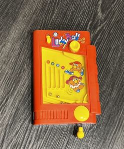 vintage Lucky Ball hand held pinball wind up skill game in the red box