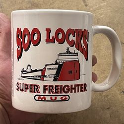 collectible ceramic mug featuring a graphic of the "Roger Blough" 1,000-foot freighter at the Soo Locks.  It is a souvenir mug commemorating the Soo L