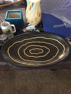 Large oval black and gold bowl