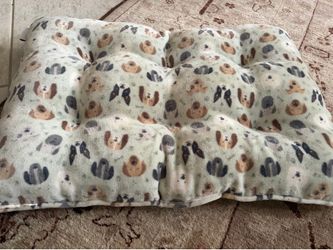 Soft padded new pet bed with cute little dog and cat faces. Both sides are the same pictures are of each side.
