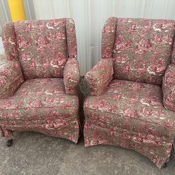 Wingback chair upholstered w/ Red and Sage toile fabric.