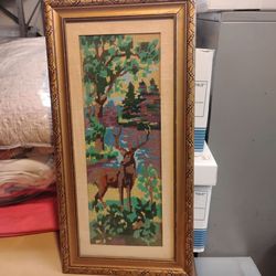 Antique framed needlepoint of deer in the woods.