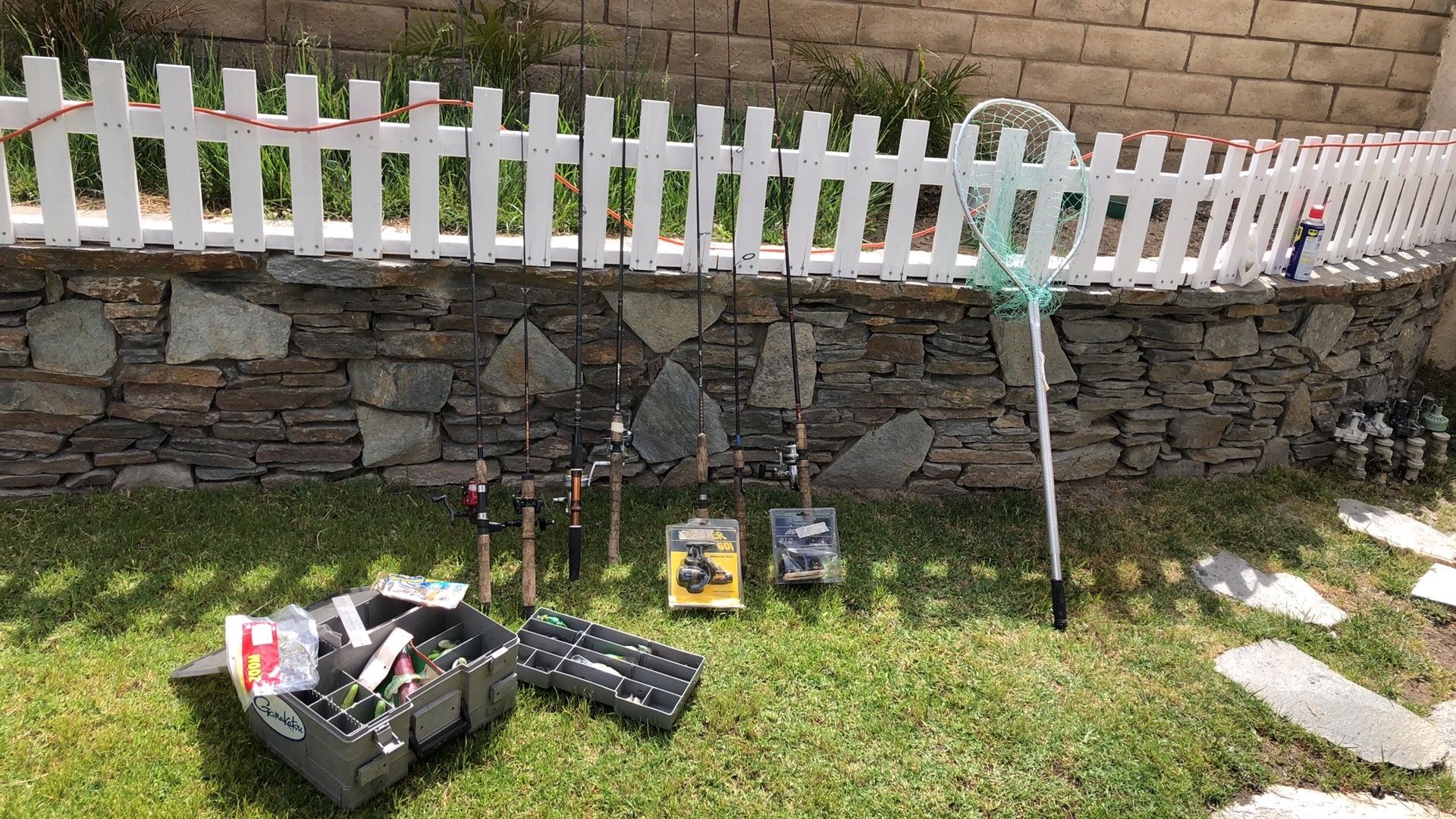 SEVEN (7) Fishing Rods with ReelsTackle Box full of LuresHook ect PLUS a net.