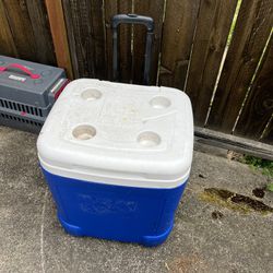 blue igloo cooler with wheels great for summer beverages of all kinds 