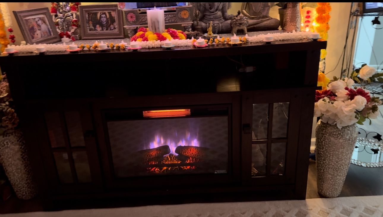 Cherry real wood rooms to go Electric fire place/TV stand it will fit 65 inch tv ,dimensions are 59 x 15.5 x 34 . In person super beautiful then pic