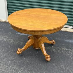 Antique tiger oak round kitchen table on wheels with one leaf 