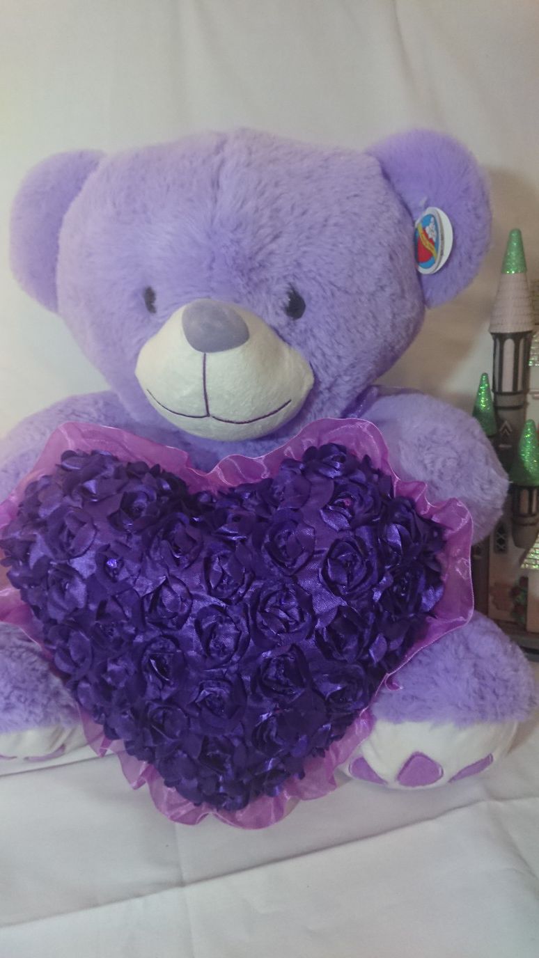 It is a beautiful teddy bear measuring 19 inches tall and 28 inches wide color purple