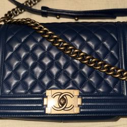 Chanel Medium Boy Bag in beautiful navy lambskin with aged gold hardware.