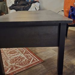 Black WOOD TV STAND 47IN X 18IN. WITH DEEP STORAGE IN THE MIDDLE. 