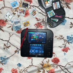nintendo 2ds with a bunch of games 