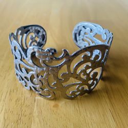 Silver Filigree Cuff Bracelet  Elegant silver cuff bracelet with intricate filigree design.  This vintage silver tone cuff bracelet features a hammere