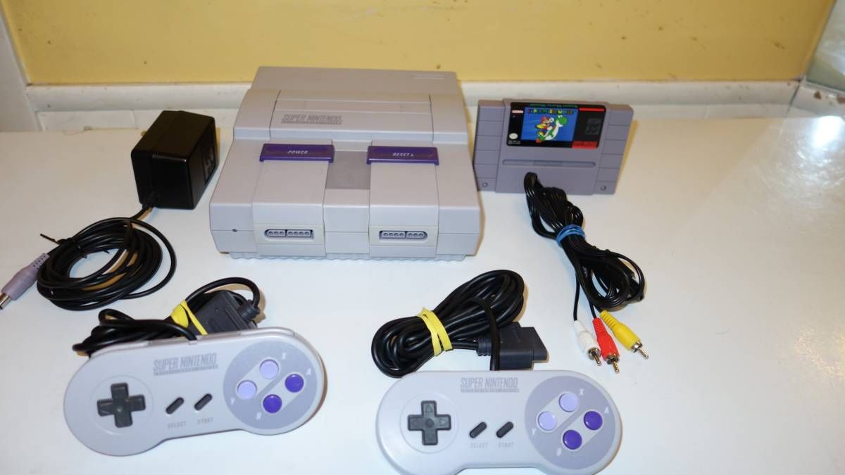 Super nintendo system with two controllers & Super mario World game