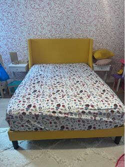 Full size yellow bed frame with mattress