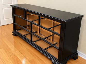 Black queen sized bed frame with dresser and mirror attachment