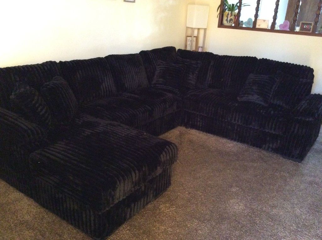 Black CURDOROY SLEEPER SECTIONAL WITH STORAGE CHAISE. (PICTURE IS CUSTOMER. YOU GET NEW)