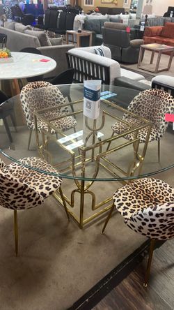 Large glass table set with chairs