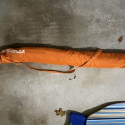 Beach Umbrella And Surfing 