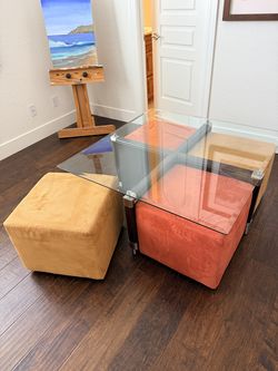Coffee table with four tuck-under ottomans 42”x42”