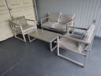 Outdoor patio couch with chairs and coffee table