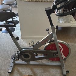 Sunny Health & Fitness Stationary Exercise Bike Machine w/ Adjustable Cushion Seat & Multi-Grip Handlebar