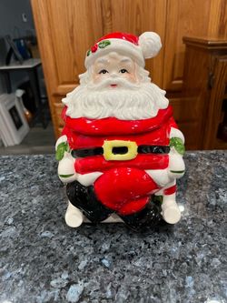 Vintage Ceramic Lefton Christmas Santa Claus Cookie Jar in Candy Cane Rocker. Preowned with sticker on the bottom. Size approximately 9 inches tall.