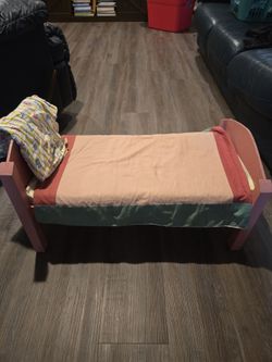 Old handmade doll bed with bedding