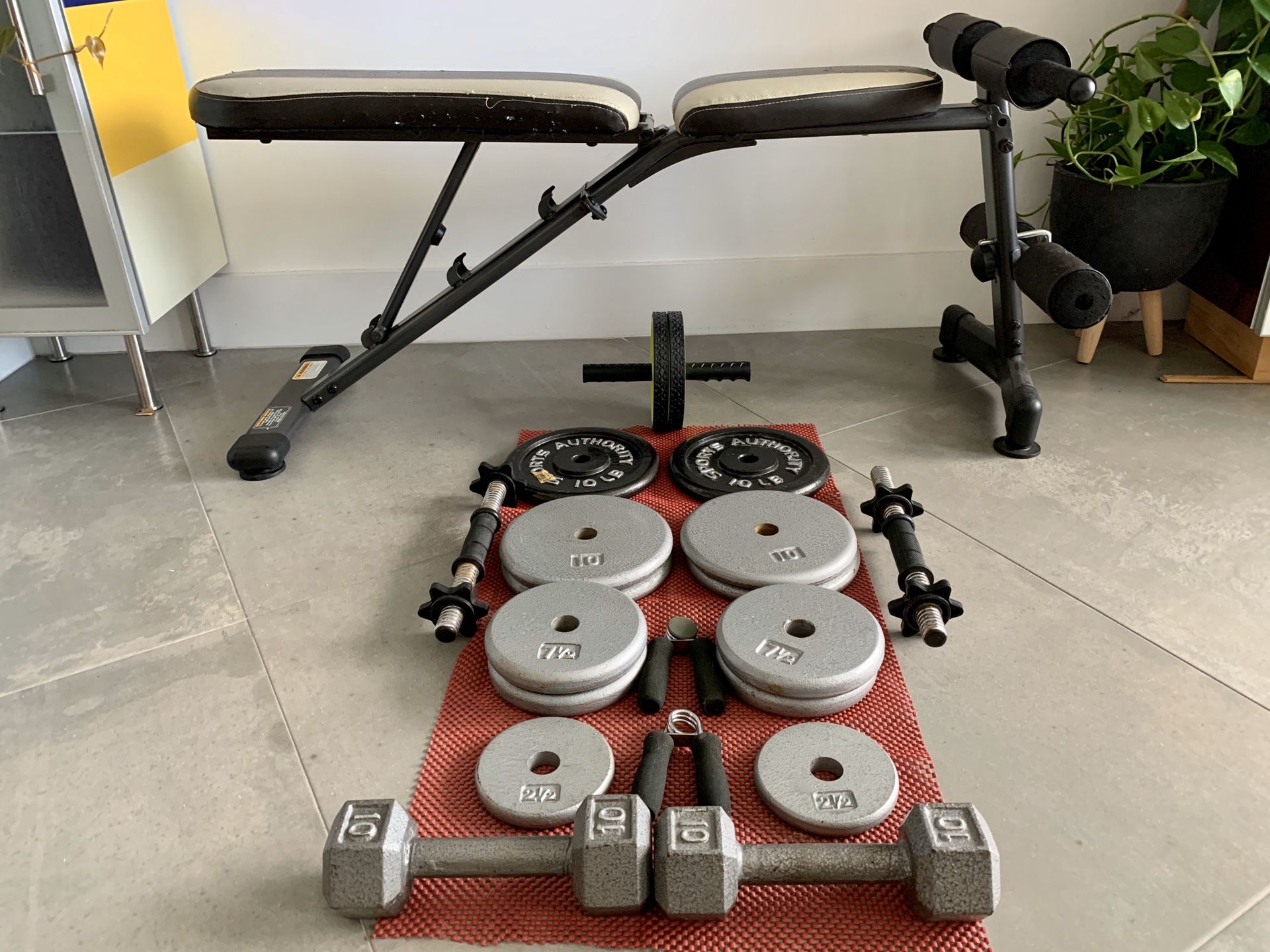 Adjustable Multi-workout weight bench and (22) Weight Plates