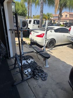 Bench press/squat rack with 7ft 45lbs bar plus 270lbs of Olympic weights and weight tree and 5ft bar
