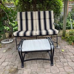 Wrought iron bench with cushions and side table