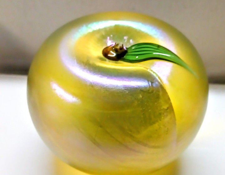 This art glass paperweight apple by Orient & Flume has a beautiful aurene gold green color. The paperweight is a little under 3" Tall