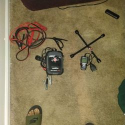 Battery Charger , Engine Reader, Jumper Cables, Tire Rod 4way ,and gas jug.