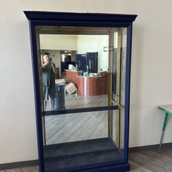 Cabinet With Glass Shelves And Mirror Back Drop
