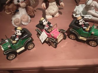 3 piece, Mickey Mouse from Disneyland wind up cars still tagged $80. Two gremlins dolls , thick plastic eighty dollars for the two pieces stackable do