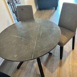 A dining table with 2 chairs and 2 additional chairs up for sale