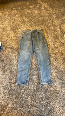 light blue adika small jeans with ripped seams as design on top